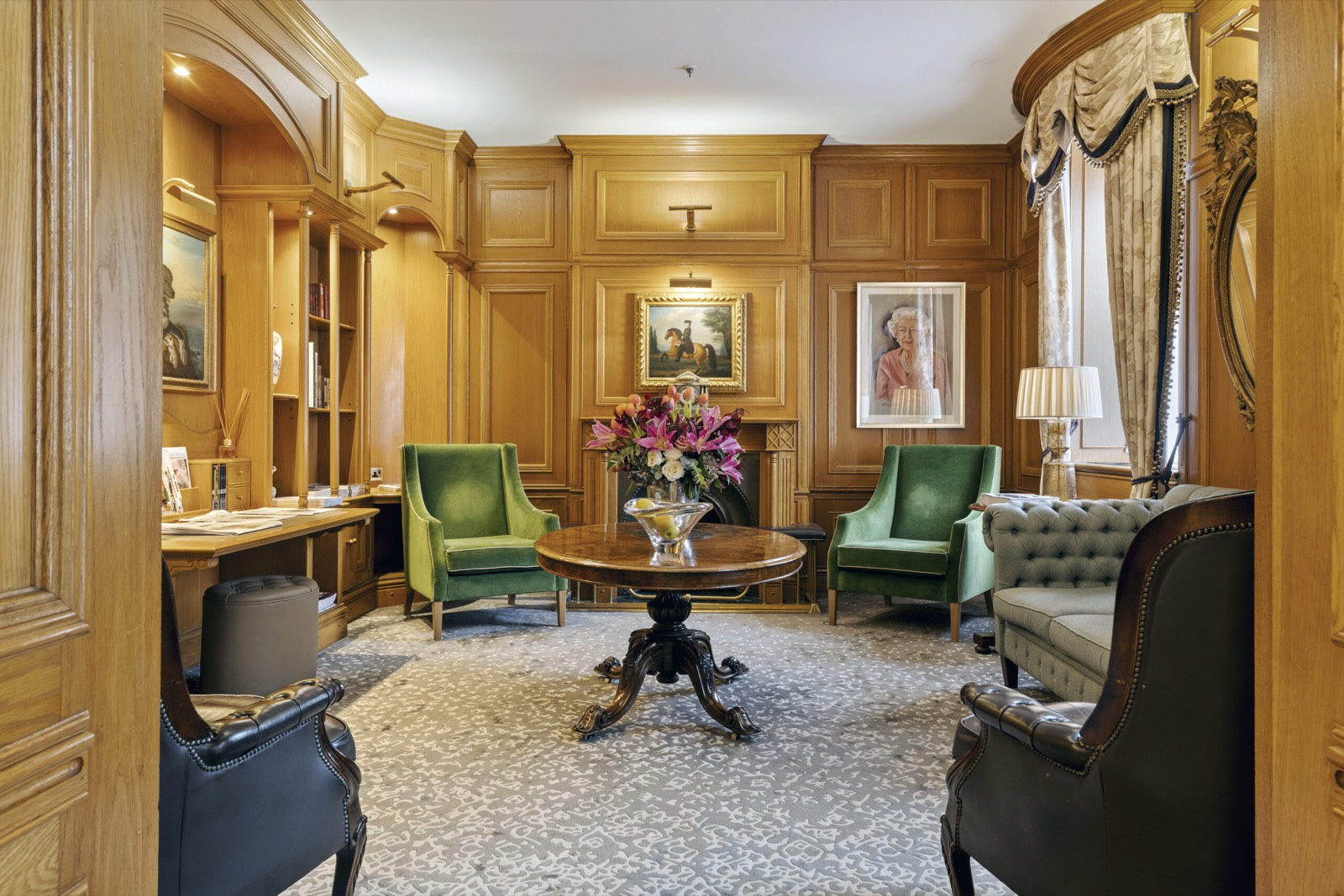 Residents' lounge with green velvet armchairs