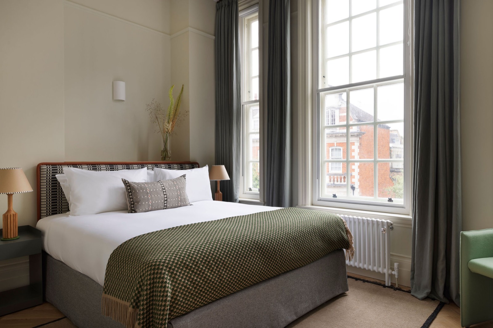 Bedroom beneath tall sash windows