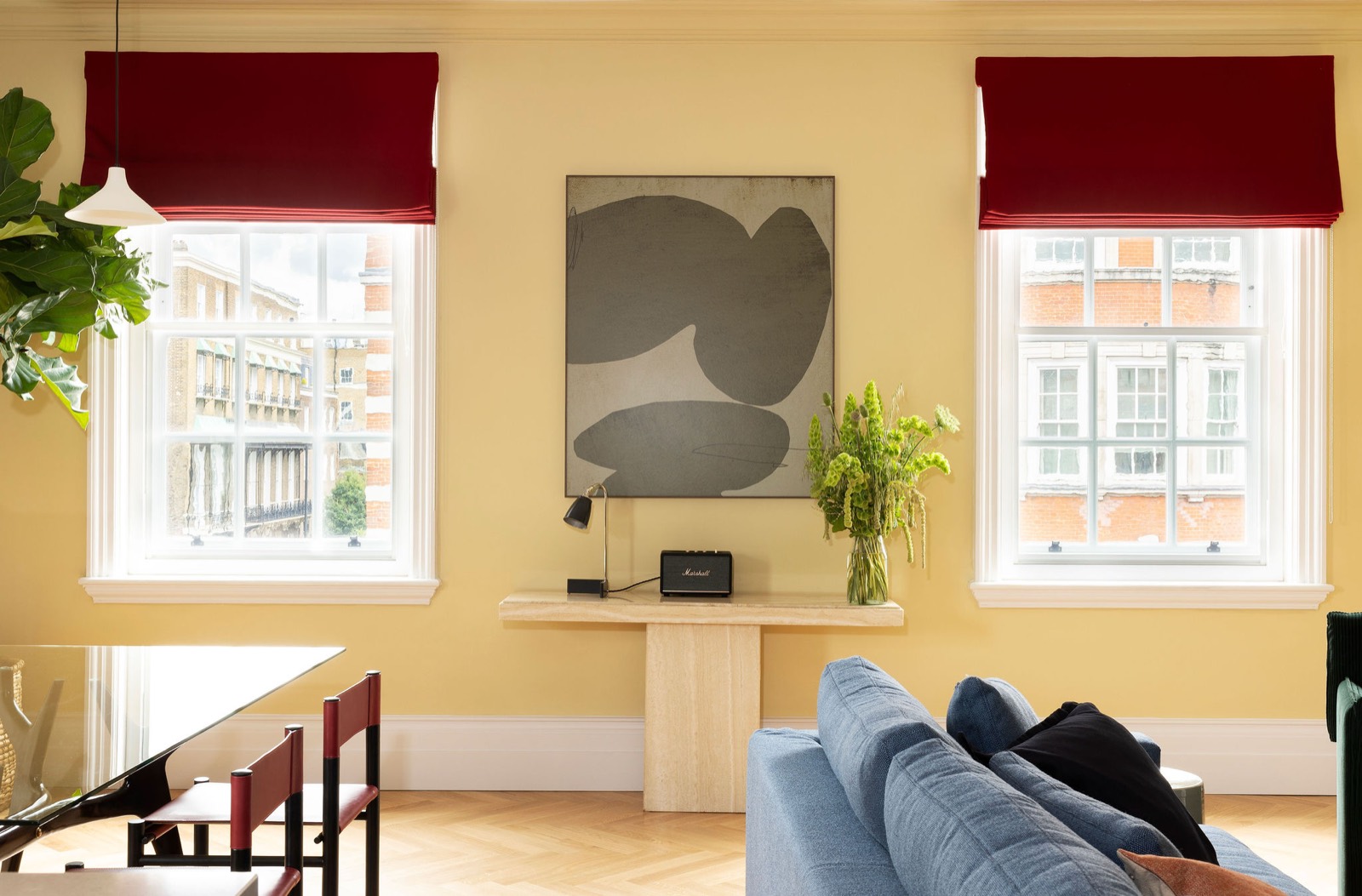 Console and artwork between tall sash windows