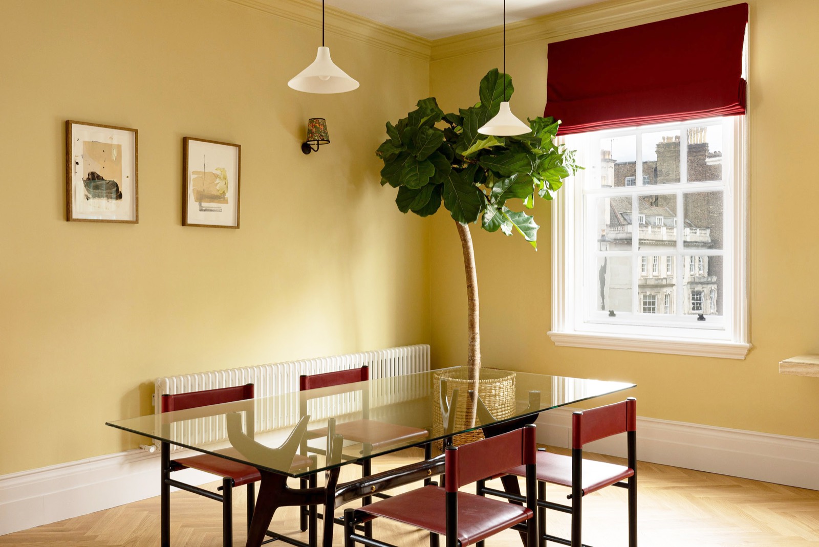 Glass dining table with red leather chairs