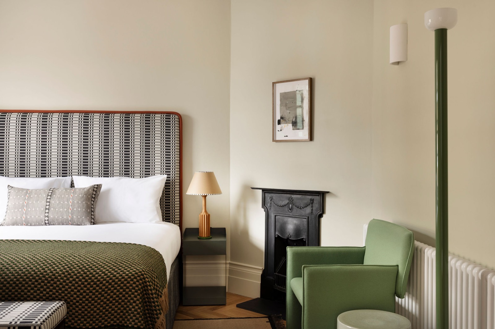 Green armchair by the bedroom fireplace