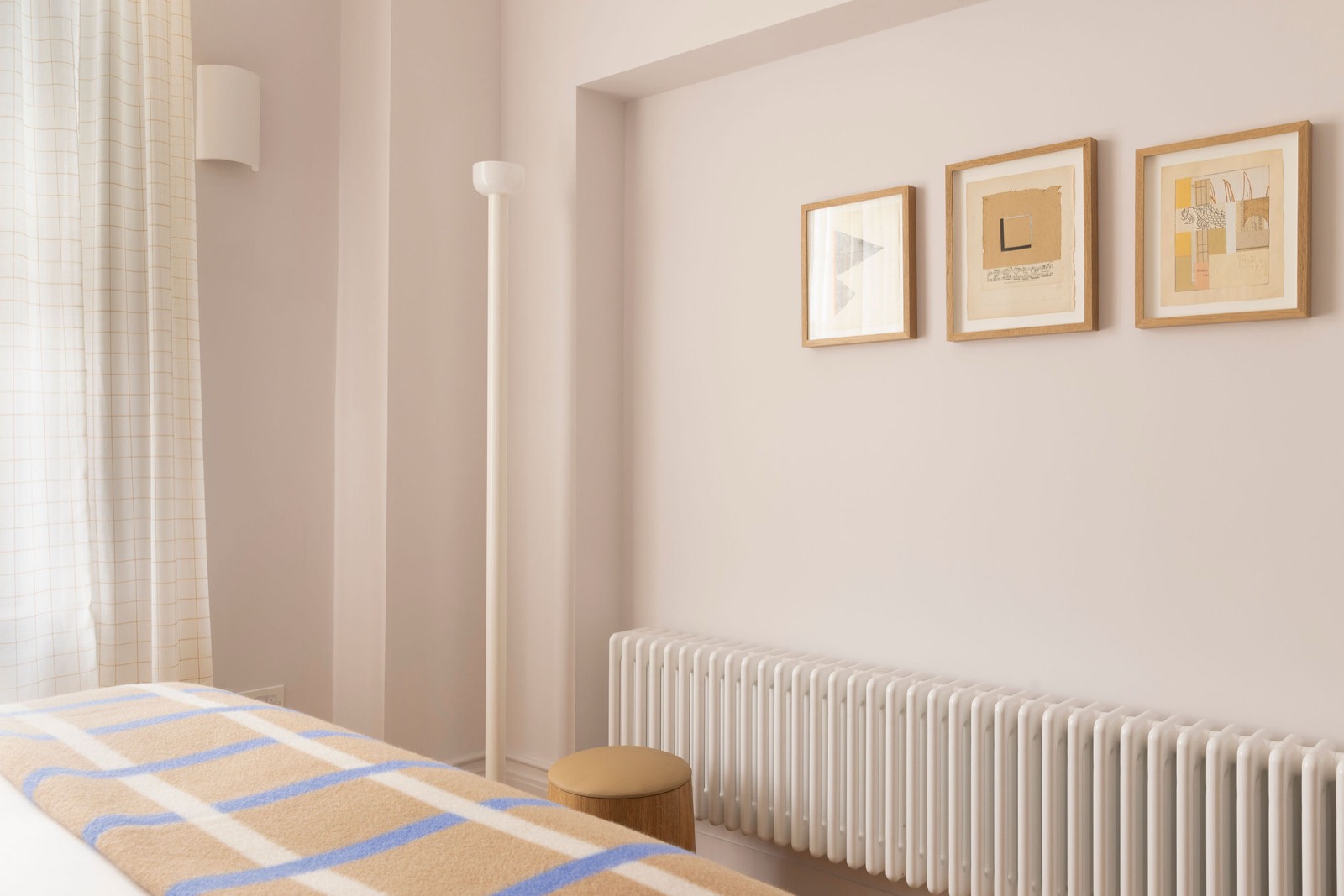 Framed prints above the bedroom radiator