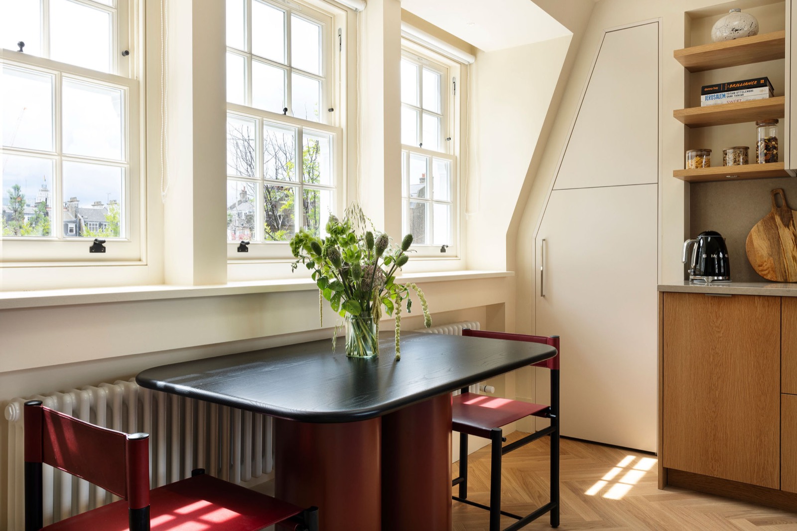 Dining table beneath the sash windows