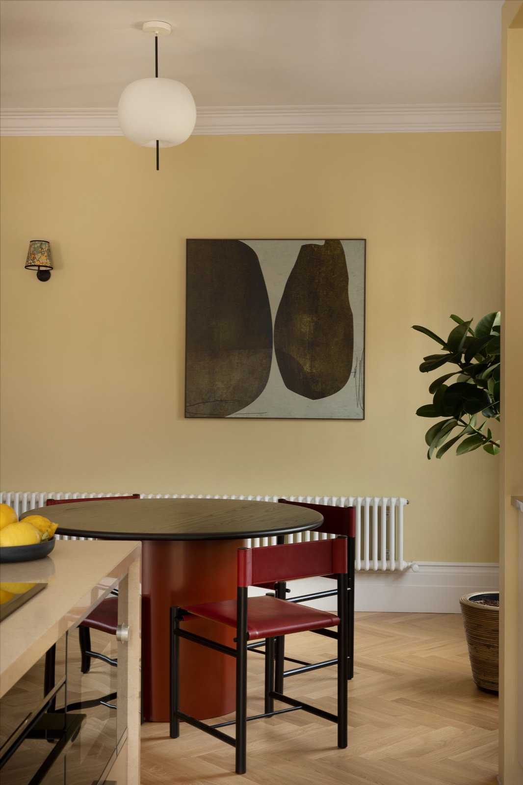 Round dining table with red leather chairs