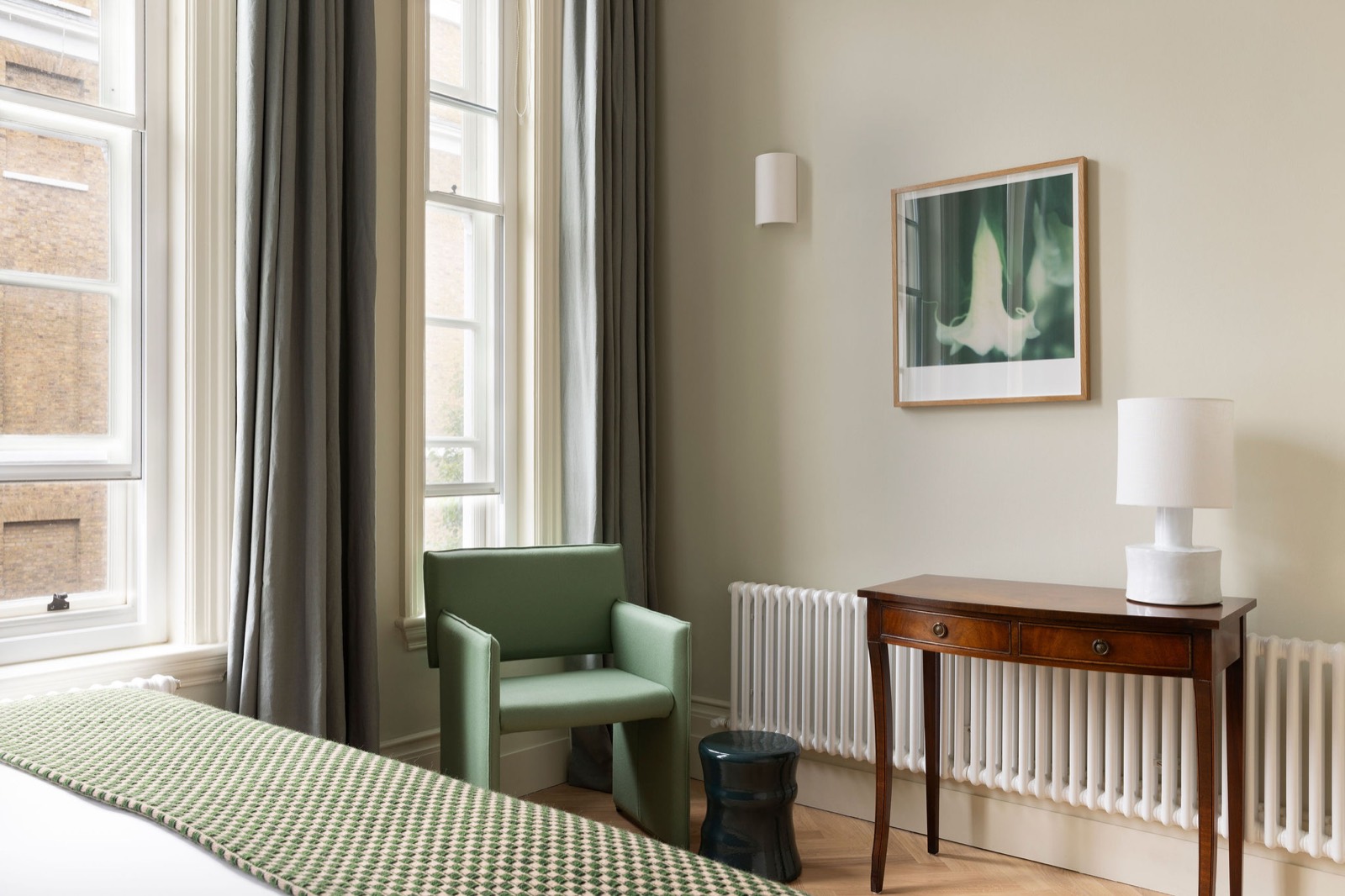 Green armchair by the bedroom windows