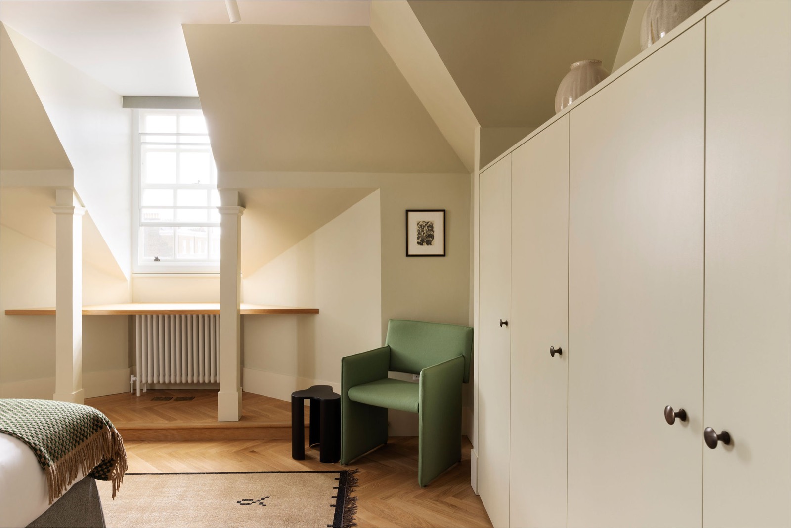 Green armchair beside the dormer window