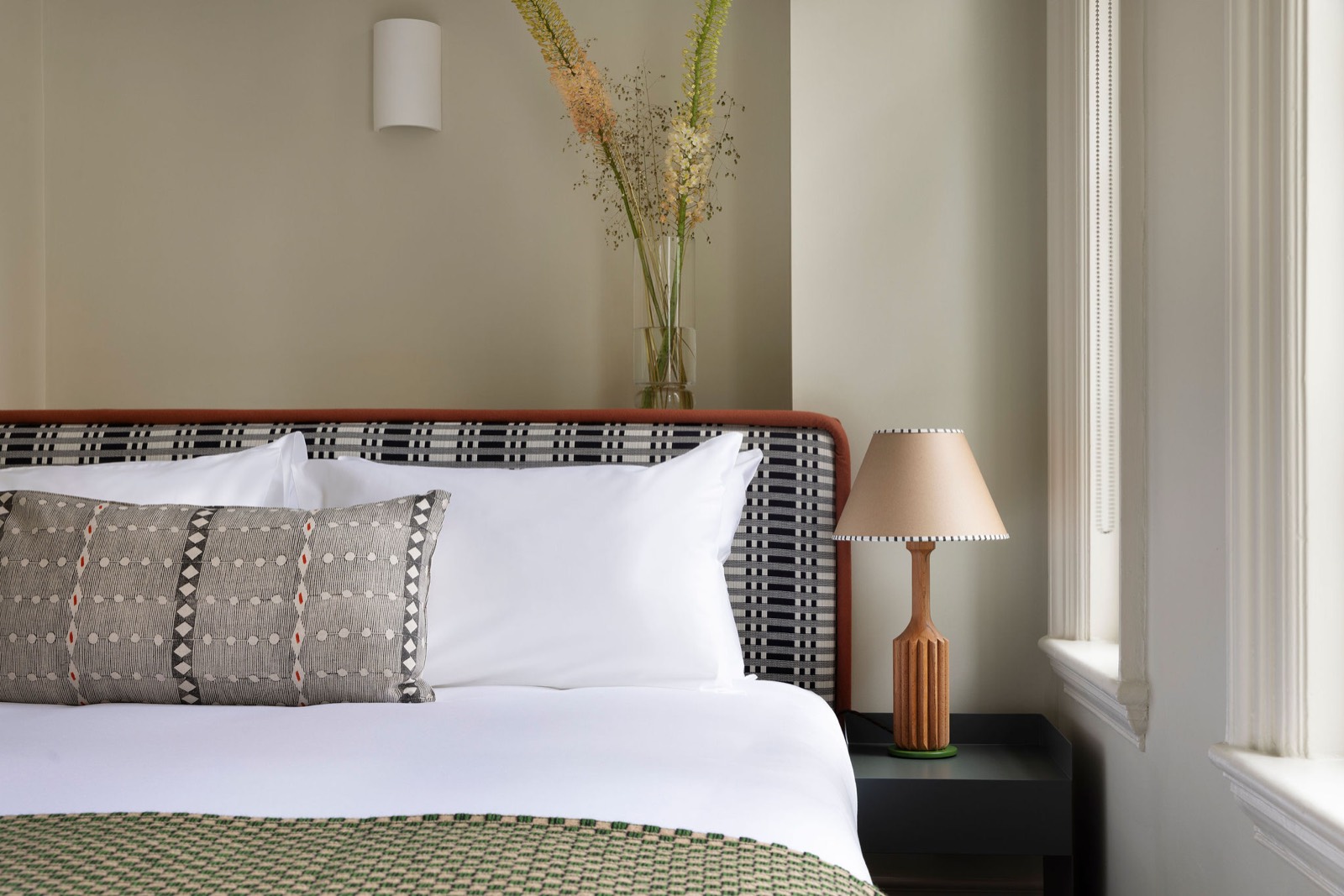 Bedside lamp and checked headboard