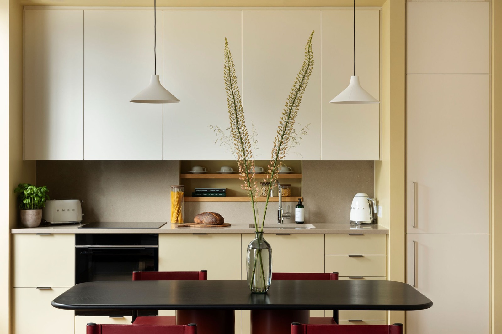 Kitchen with hob, oven and open shelving