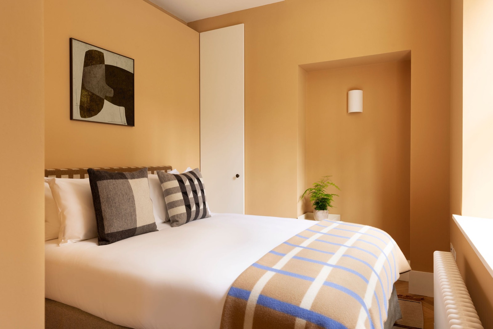 Bedroom with double bed and woven headboard