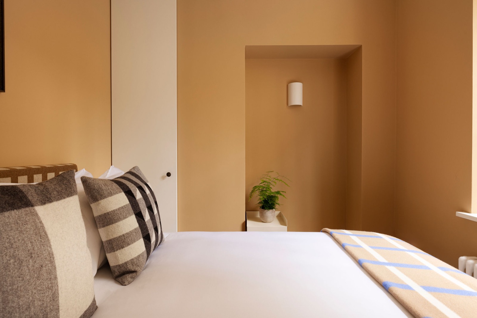 Bedside view towards the lit alcove