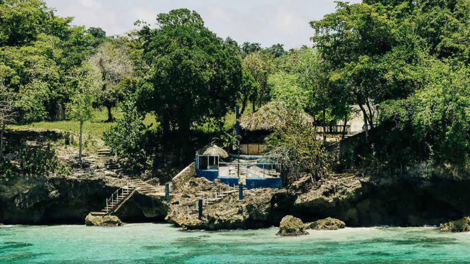 Thatched shelter above the rocky shoreline