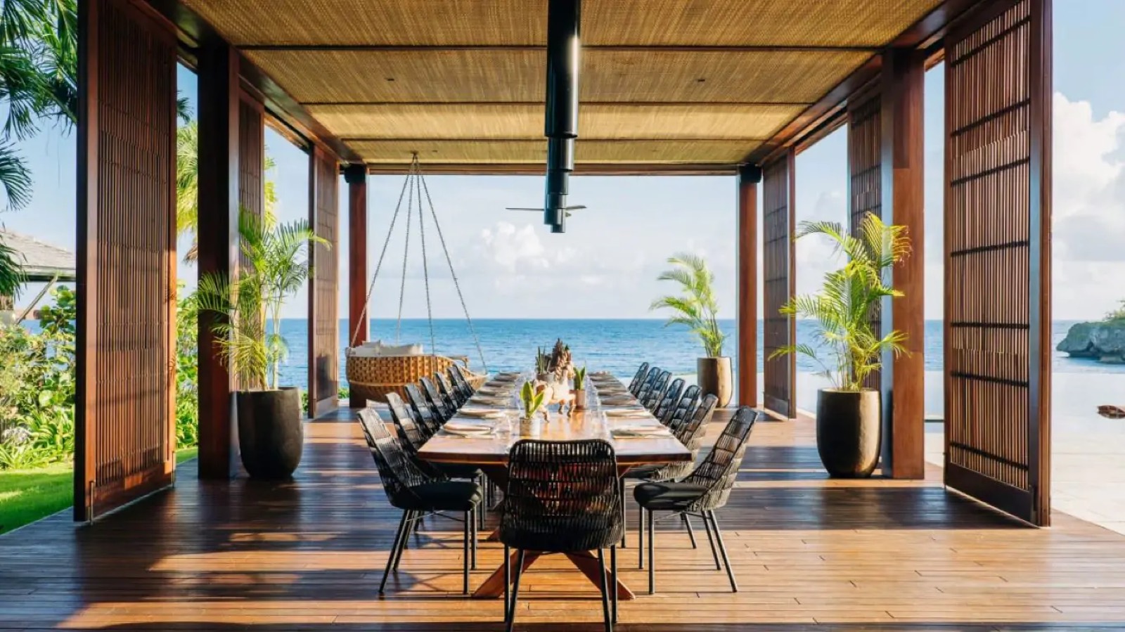 Dining table on the deck above the sea