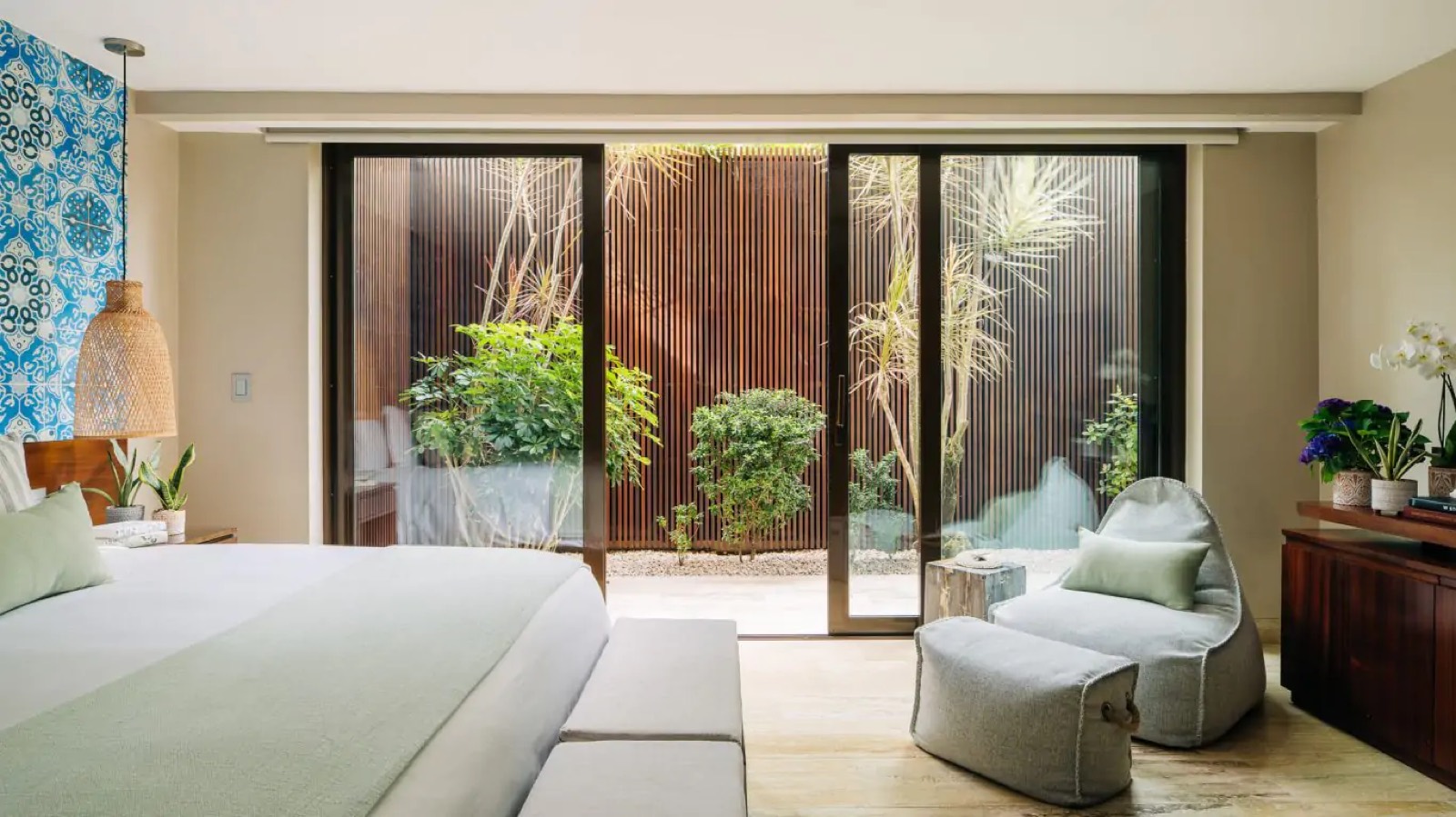 Bedroom opening onto a planted courtyard