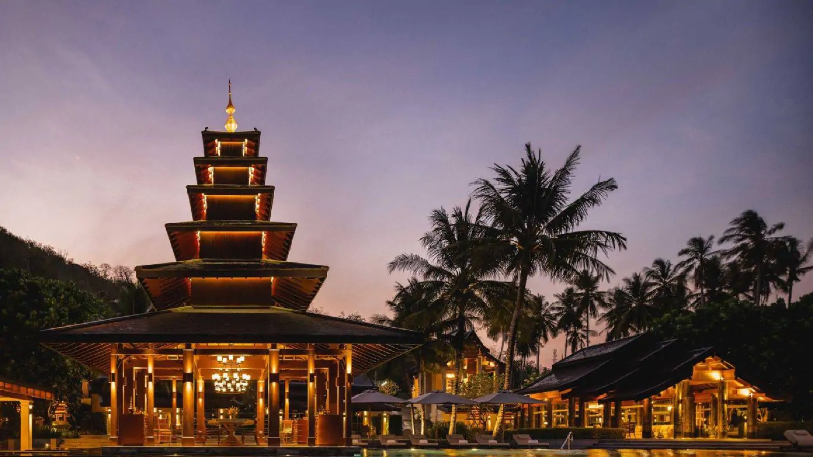 The tiered pavilion lit at dusk