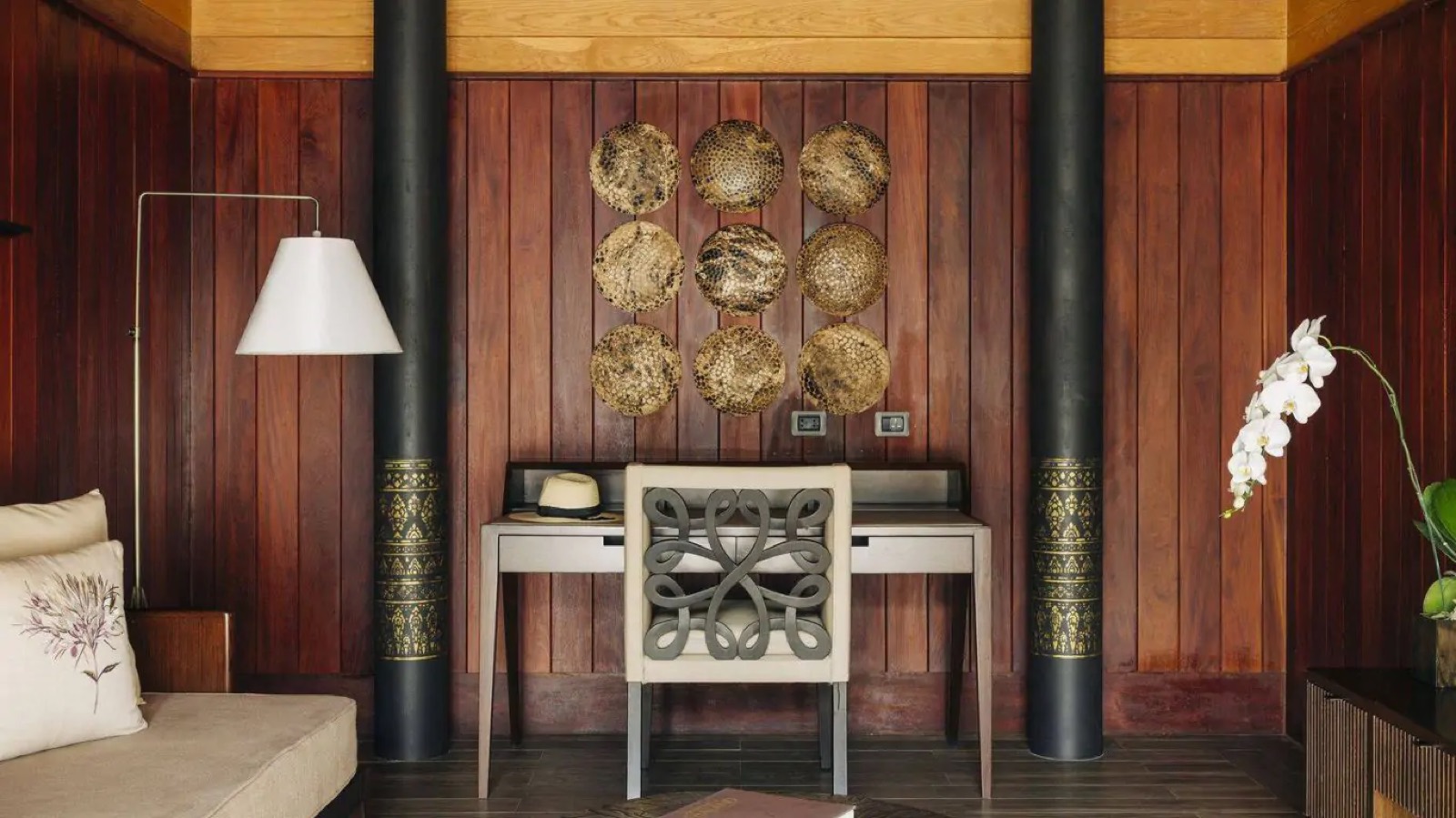 Writing desk beneath woven wall discs