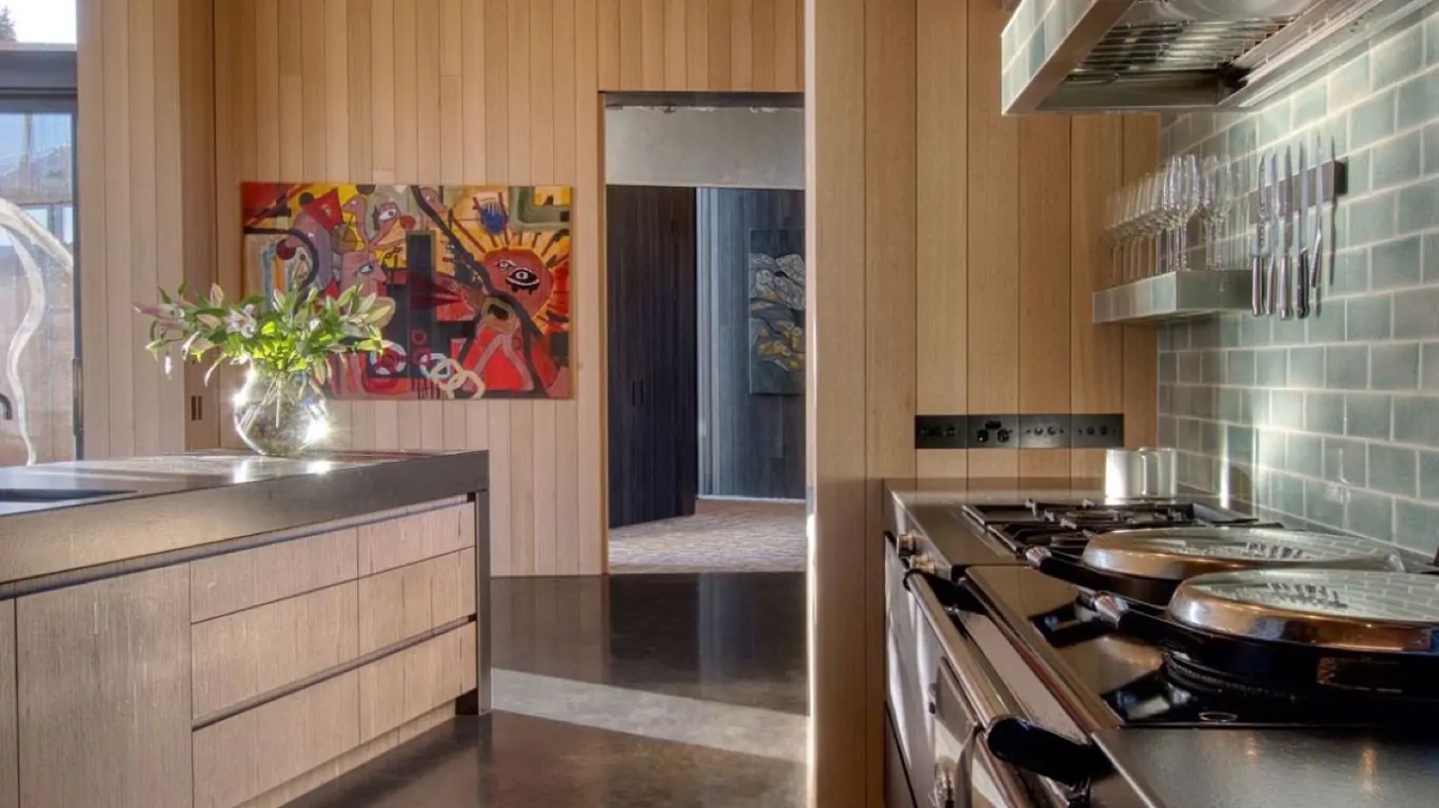 Kitchen with timber joinery and a vivid canvas