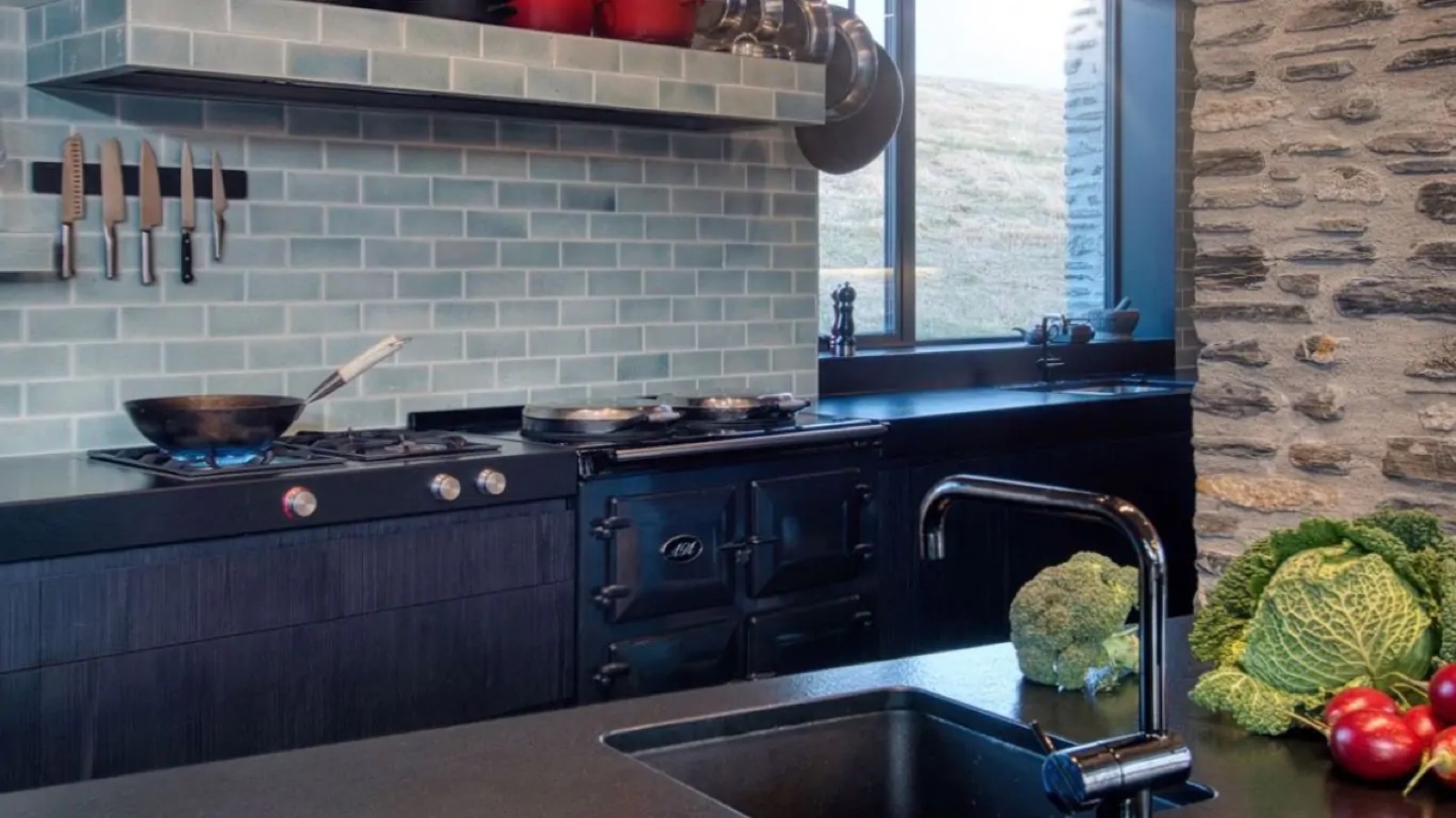 Cast-iron range beneath green tiled splashback