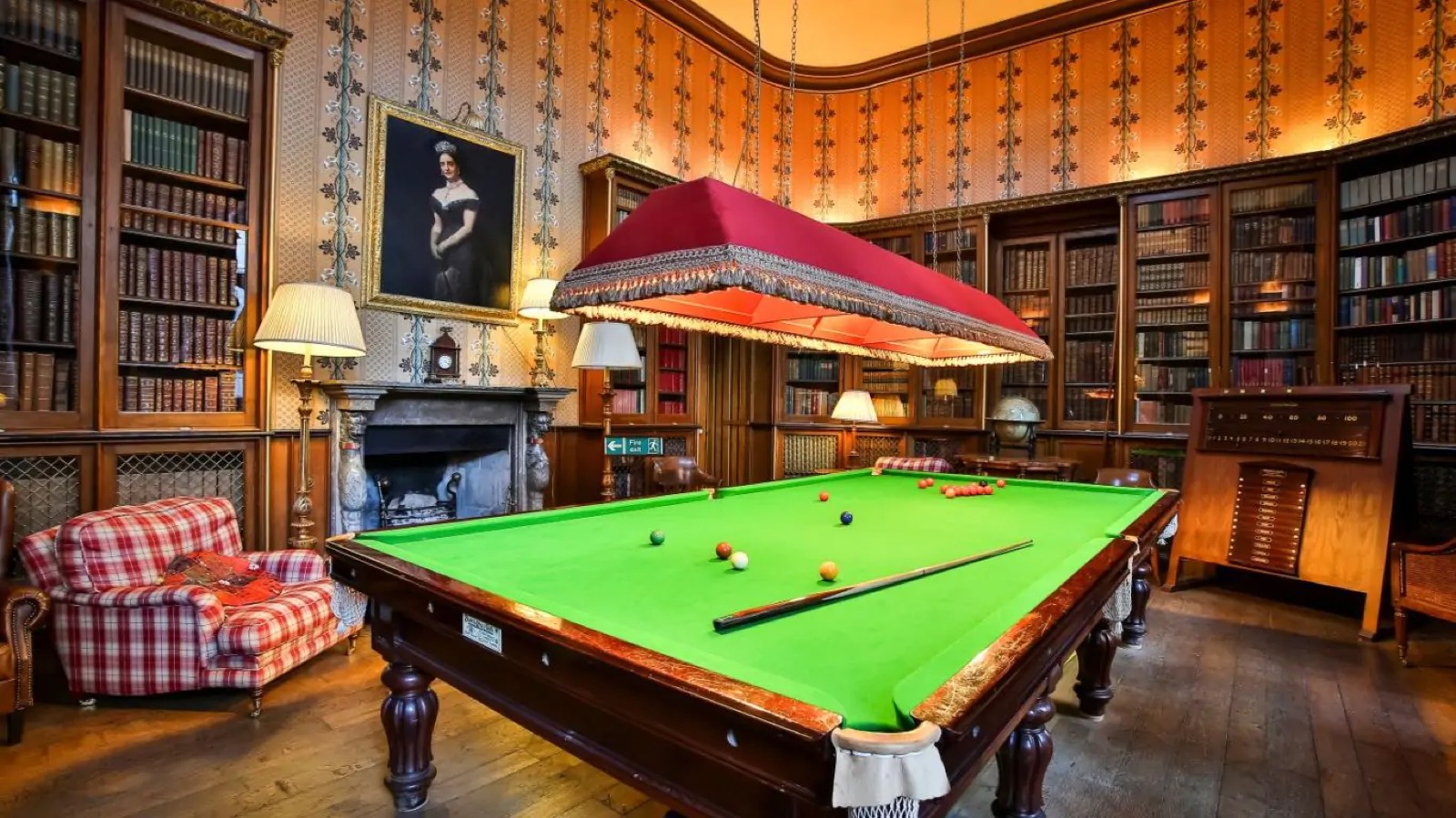Billiards room lined with bookcases