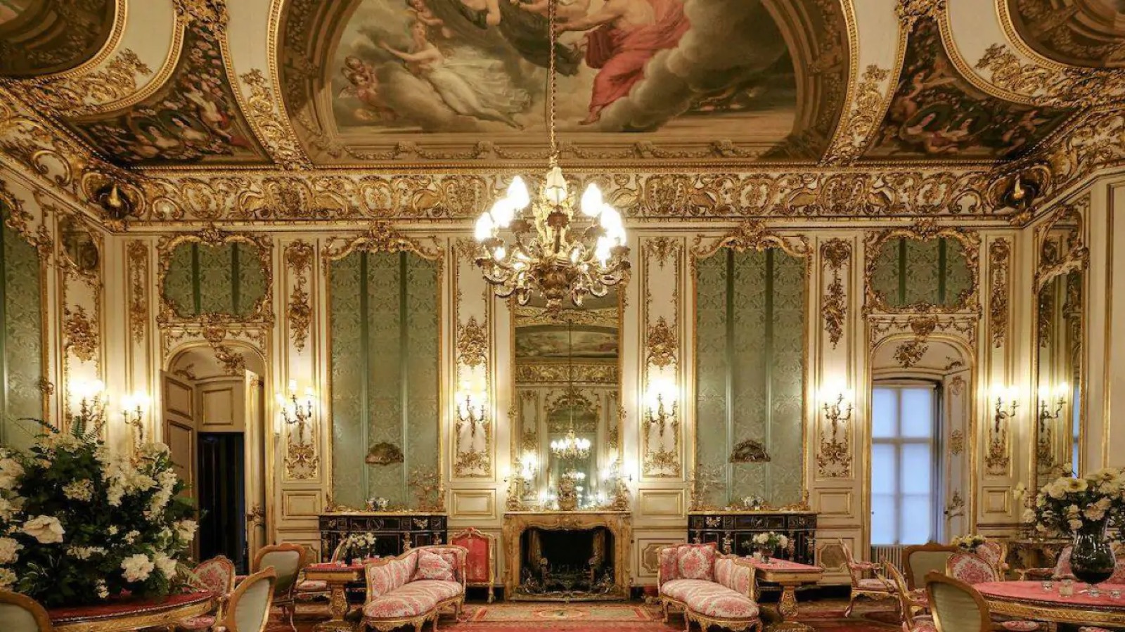 Saloon fireplace beneath the painted ceiling