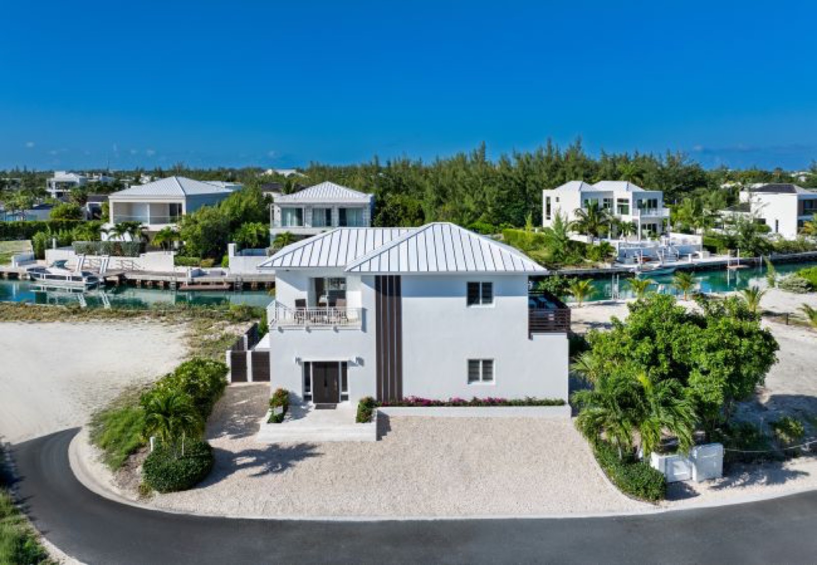 The villa from the driveway, canal behind
