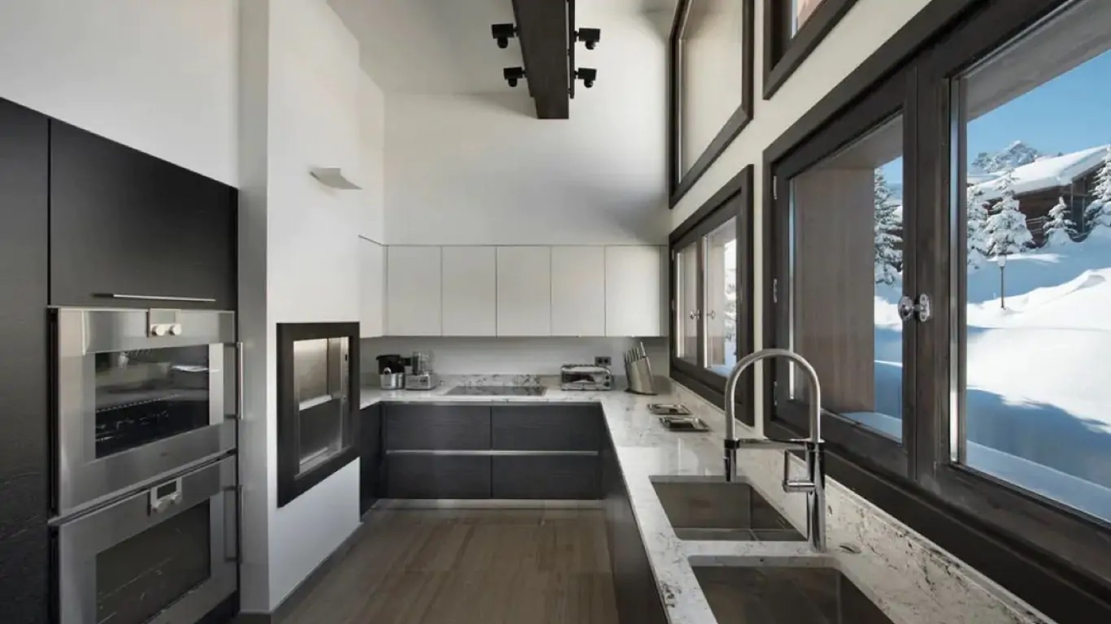 Kitchen with marble worktops and snow outside