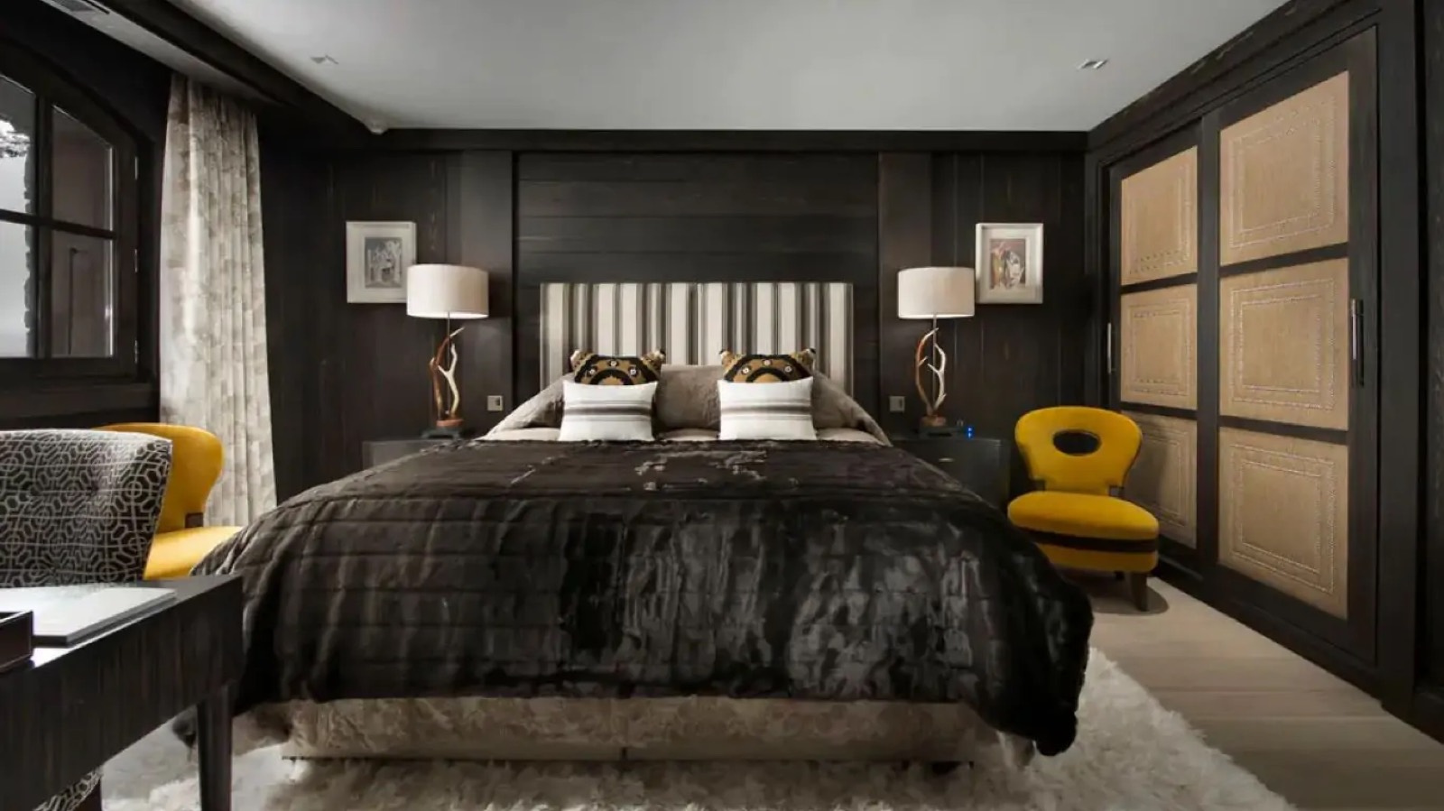 Bedroom in dark timber with striped headboard
