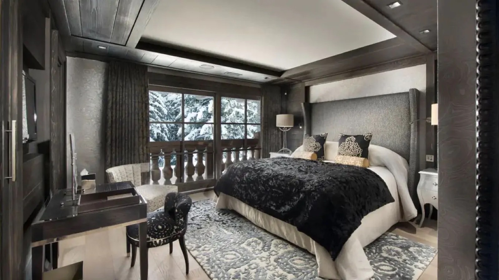 Bedroom opening onto a snow-covered balcony