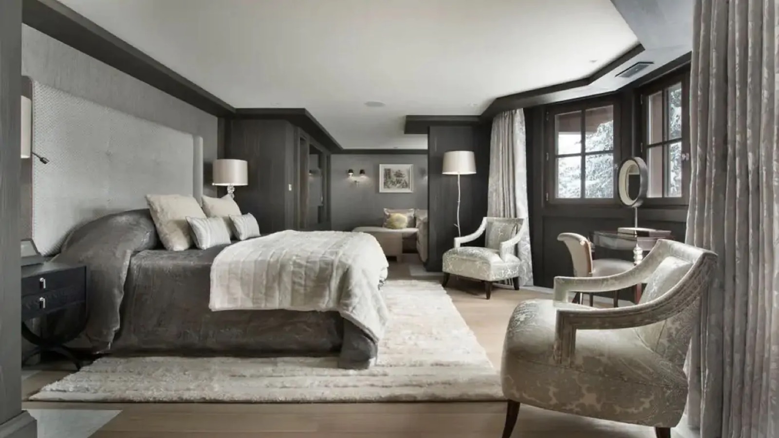 Bedroom in silver-grey with paired armchairs