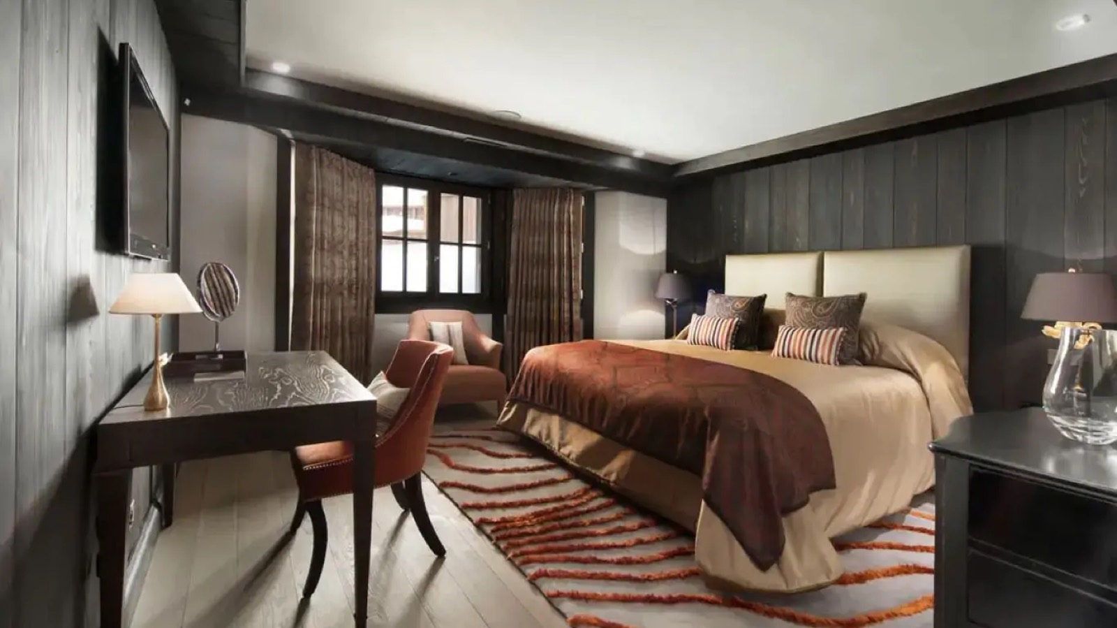 Bedroom with writing desk and copper throws