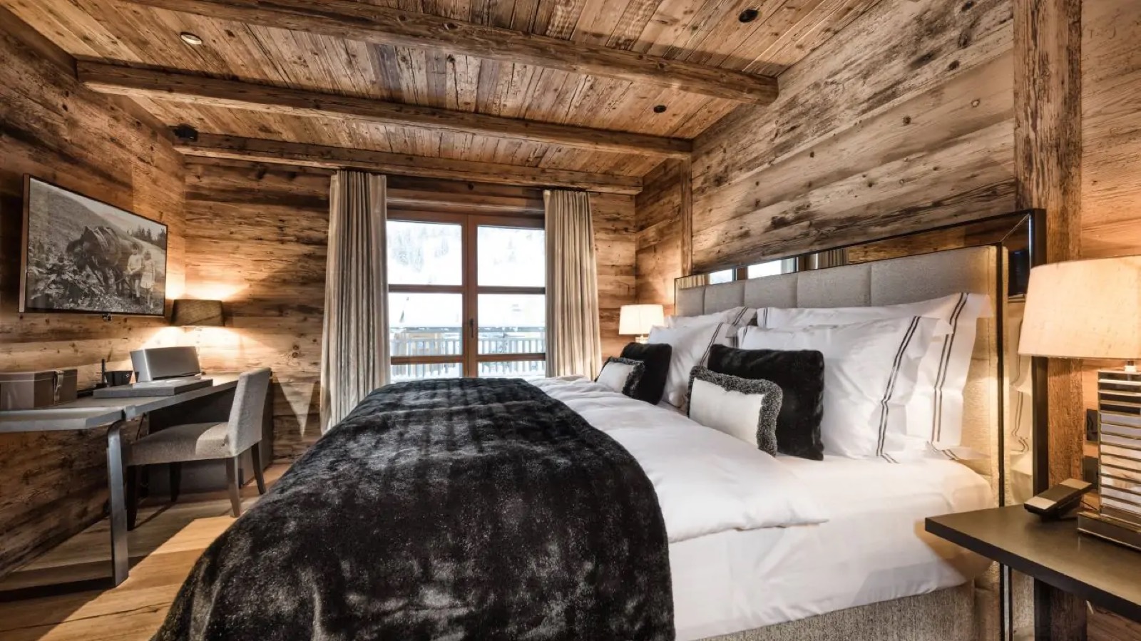 Bedroom with mirrored headboard and dark fur cover