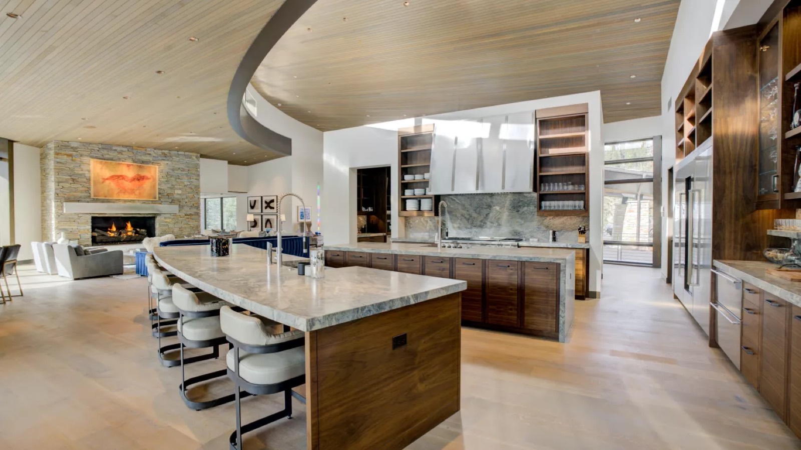 Kitchen with long stone island and stools