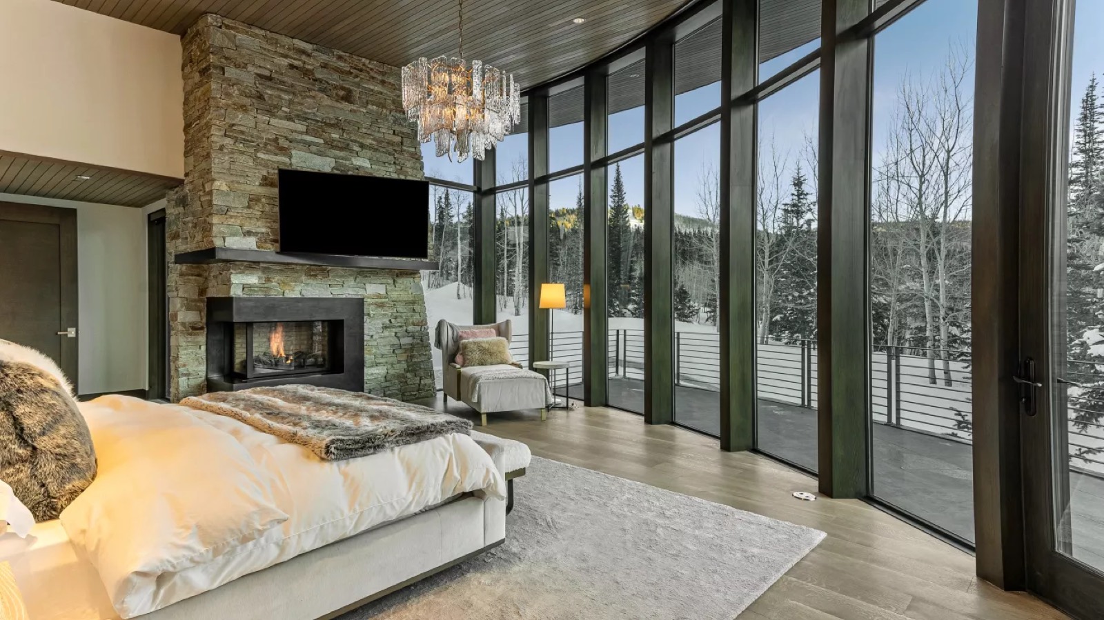 Principal bedroom with fireplace and curved glass wall