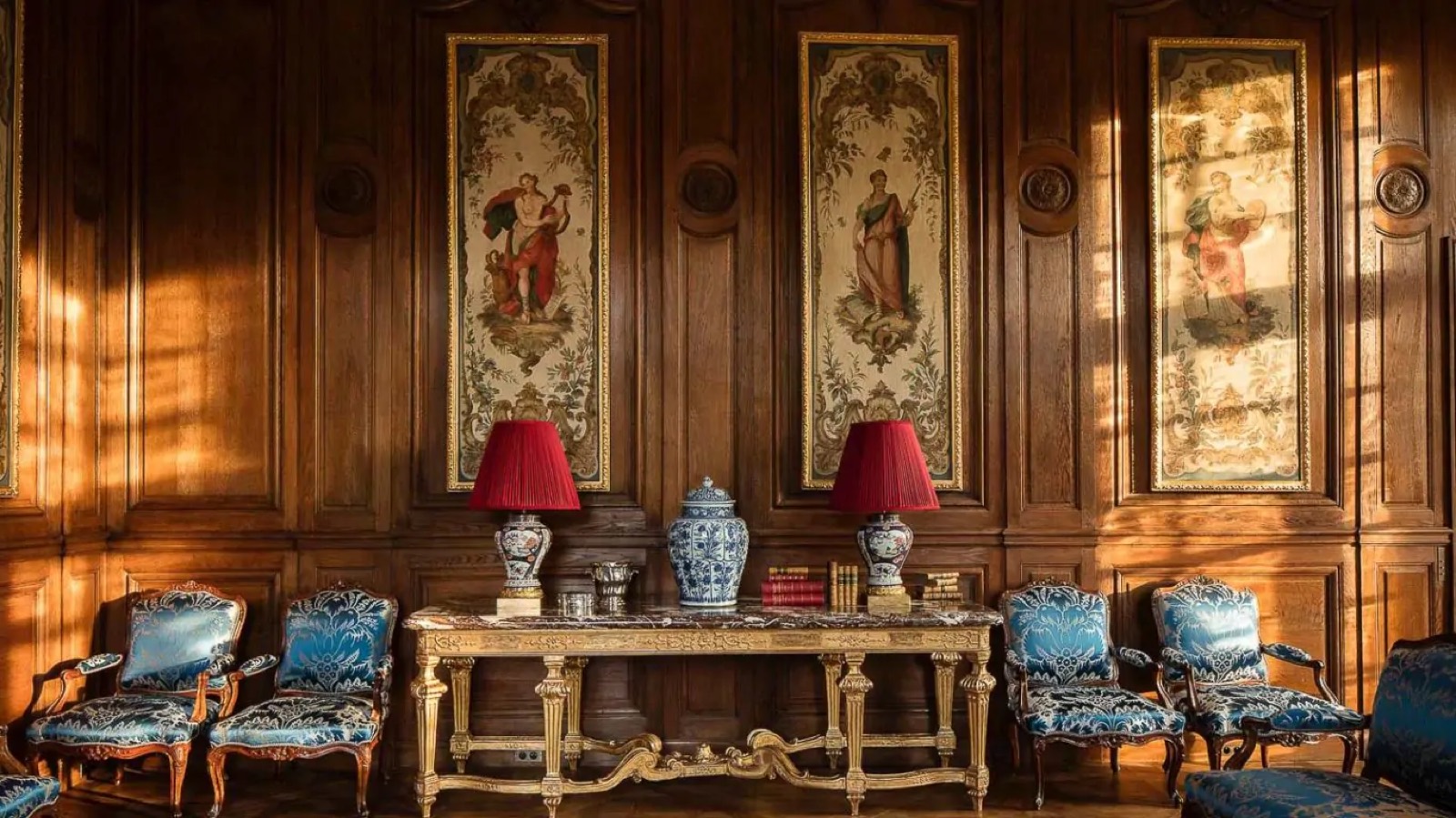 Gilt console beneath tapestry panels in the salon