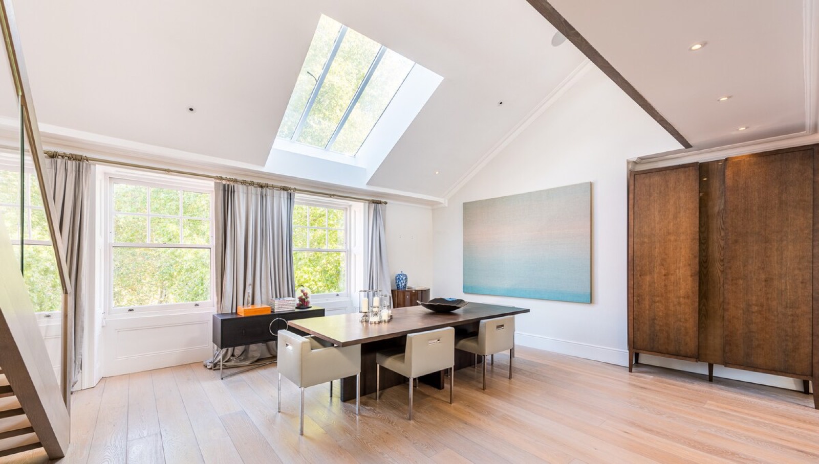 Dining room beneath a long skylight