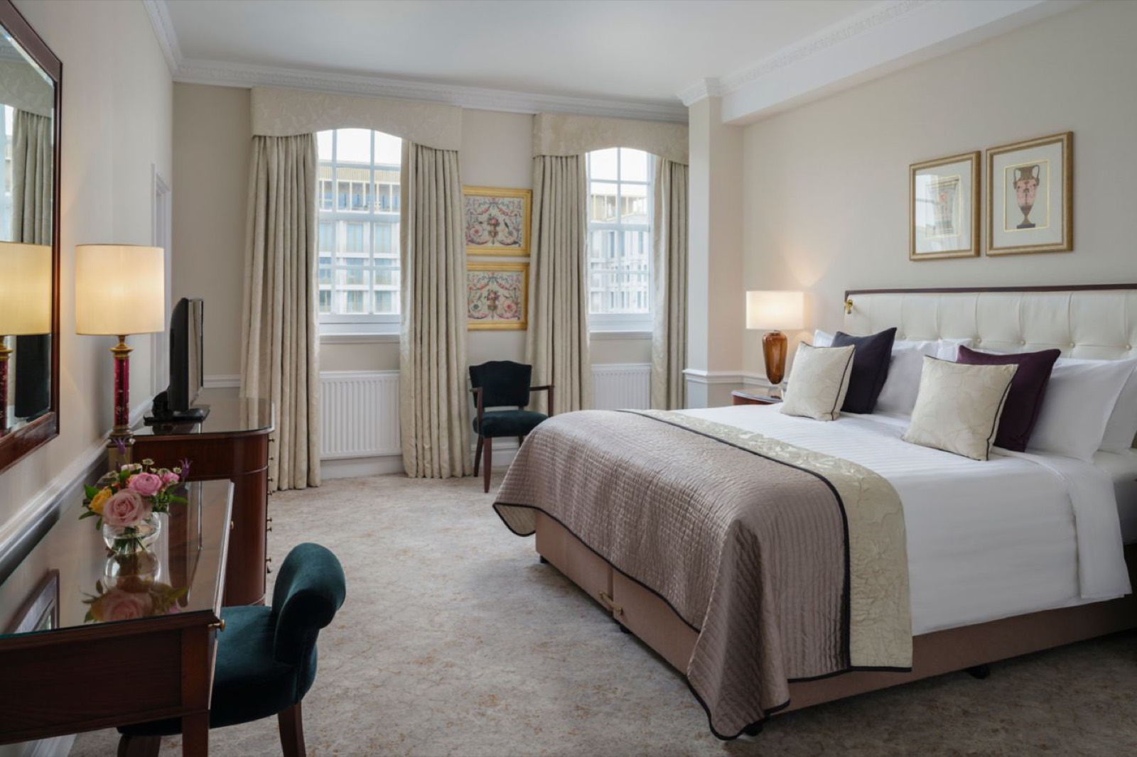 Bedroom with king bed and arched windows