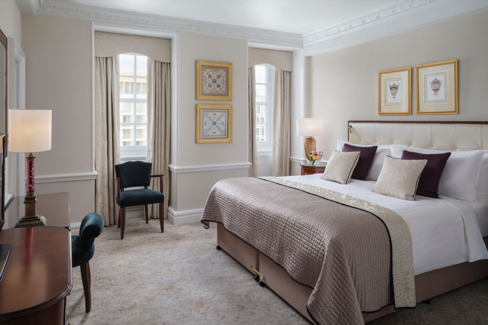 King-bedded master bedroom with arched windows