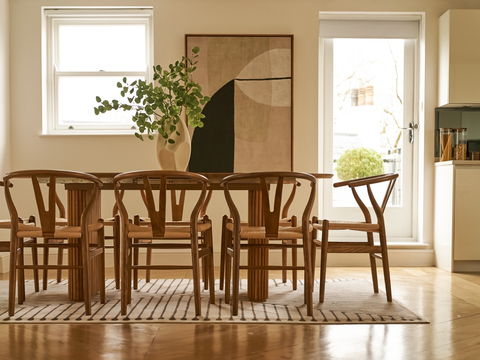 Dining table set beneath the artwork