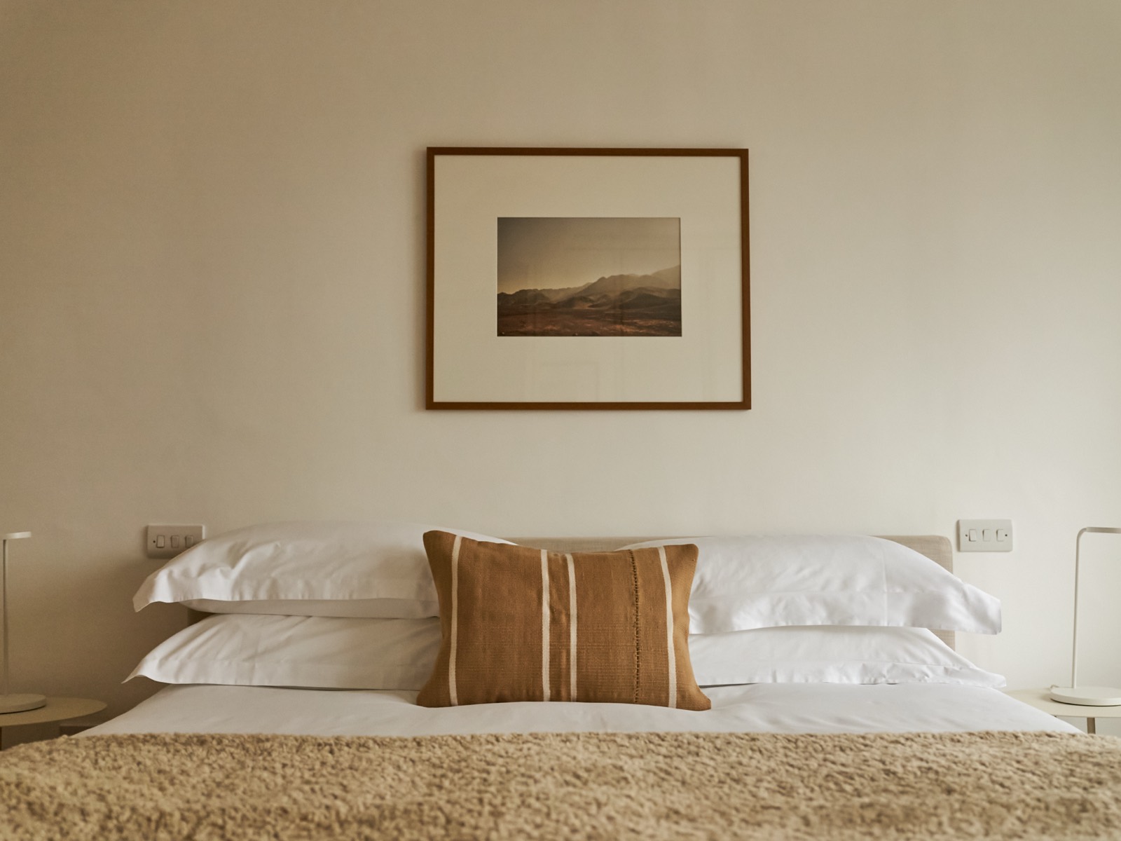 Crisp linen beneath a framed landscape