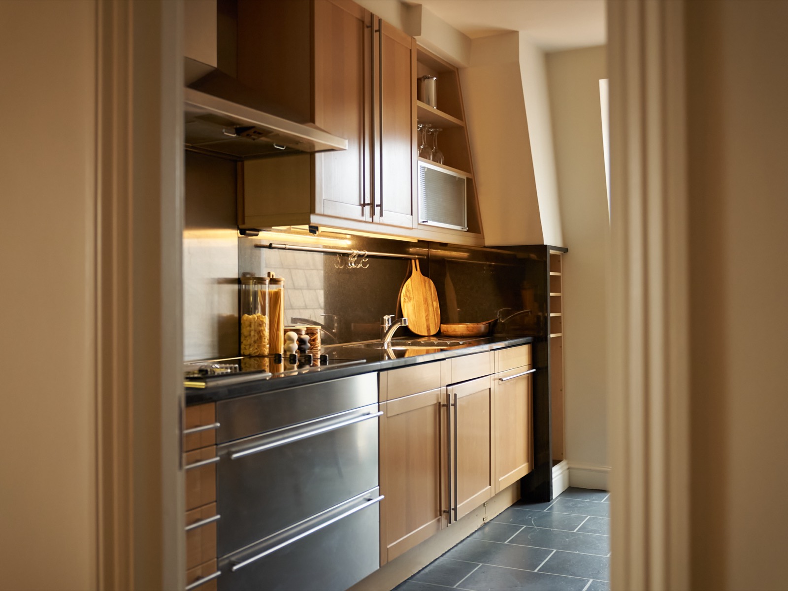 Galley kitchen with dark granite worktops