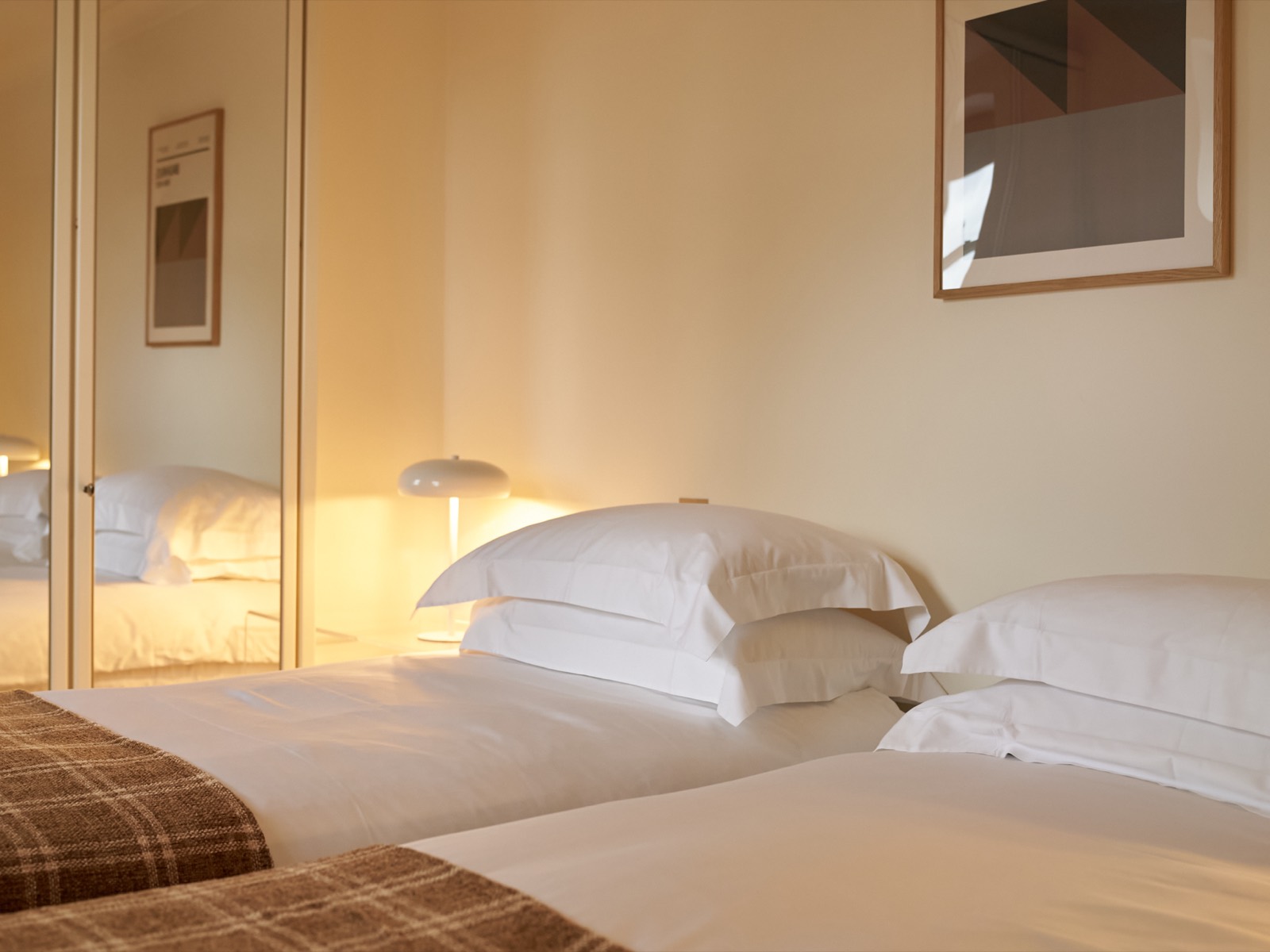 Twin beds beneath a framed print