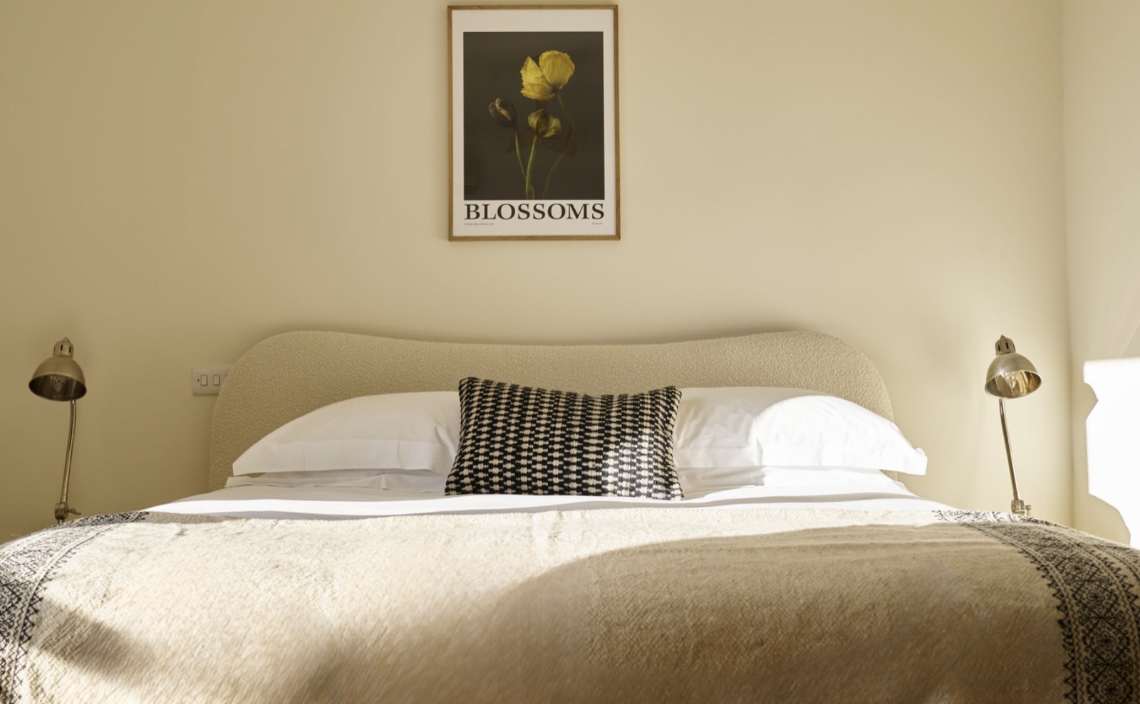 Principal bedroom with curved bouclé headboard