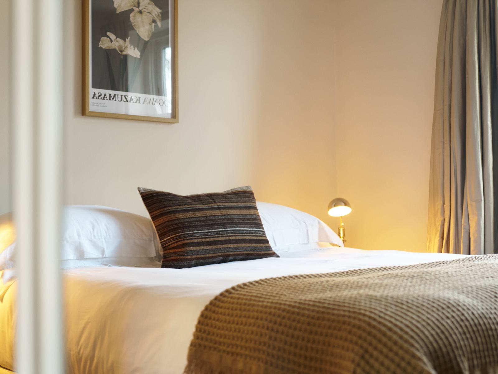 Double bed with brass wall light