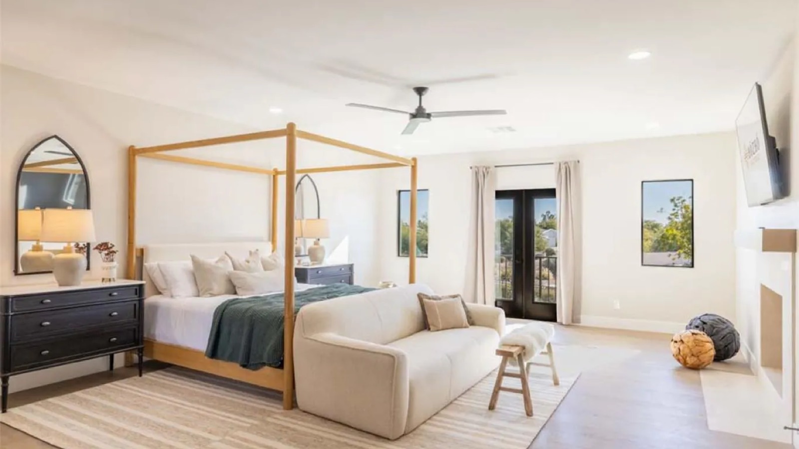 Principal bedroom with four-poster and balcony doors
