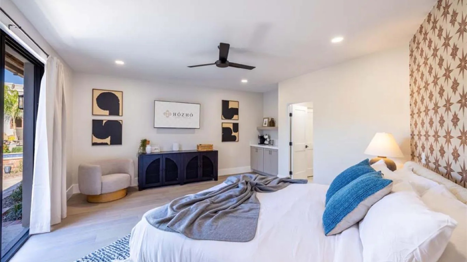 Guest bedroom with patterned wall and terrace door