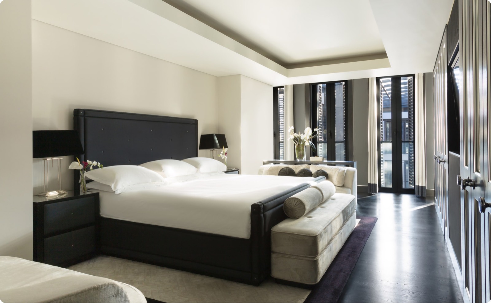 Bedroom with buttoned headboard and velvet bench