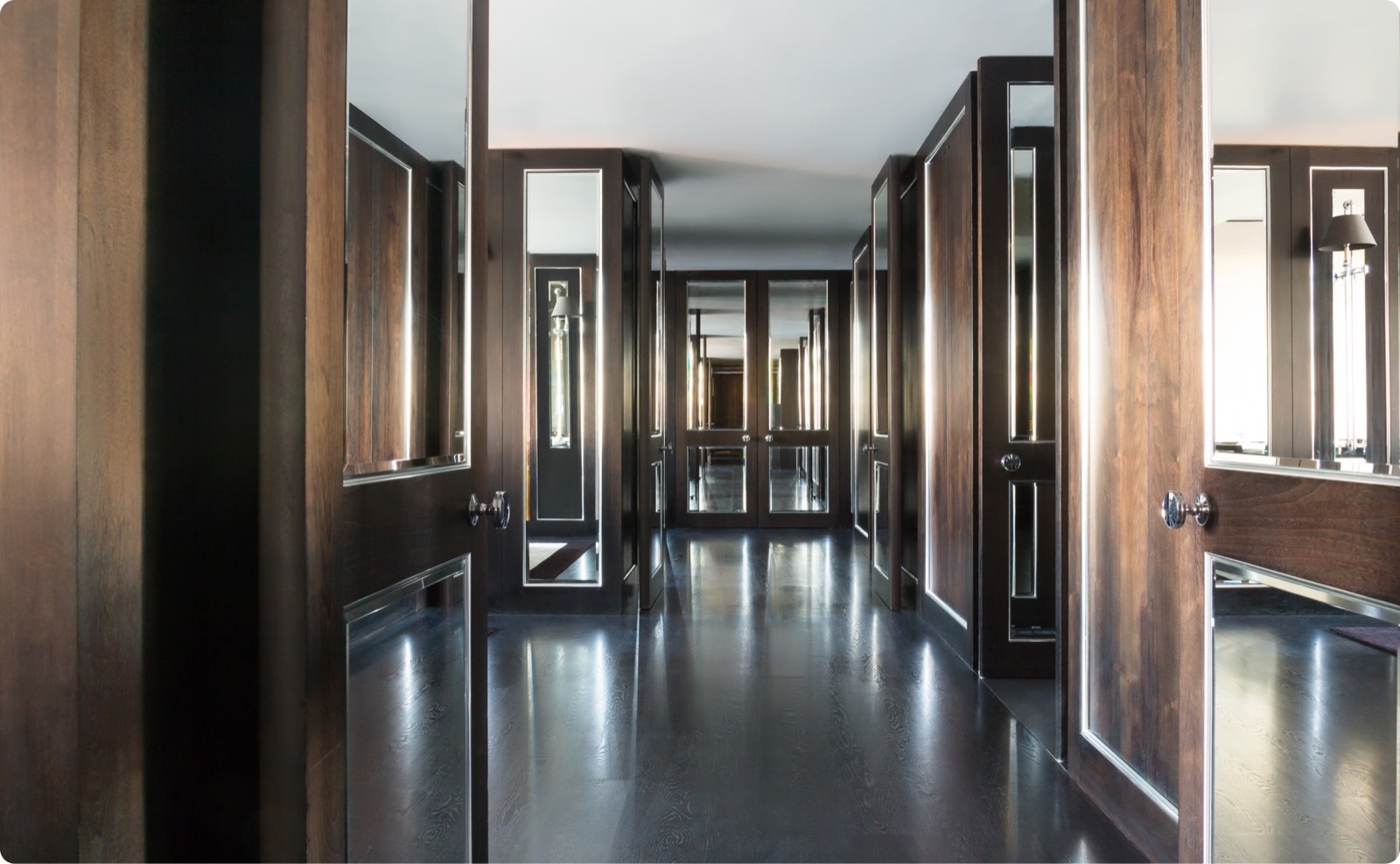 Panelled corridor with mirrored doors