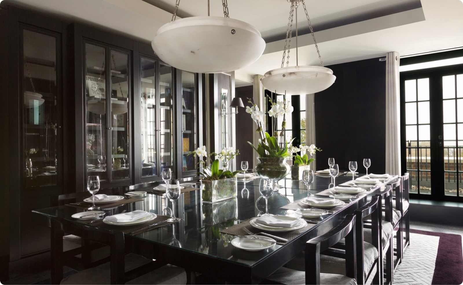Dining room set beneath alabaster pendants
