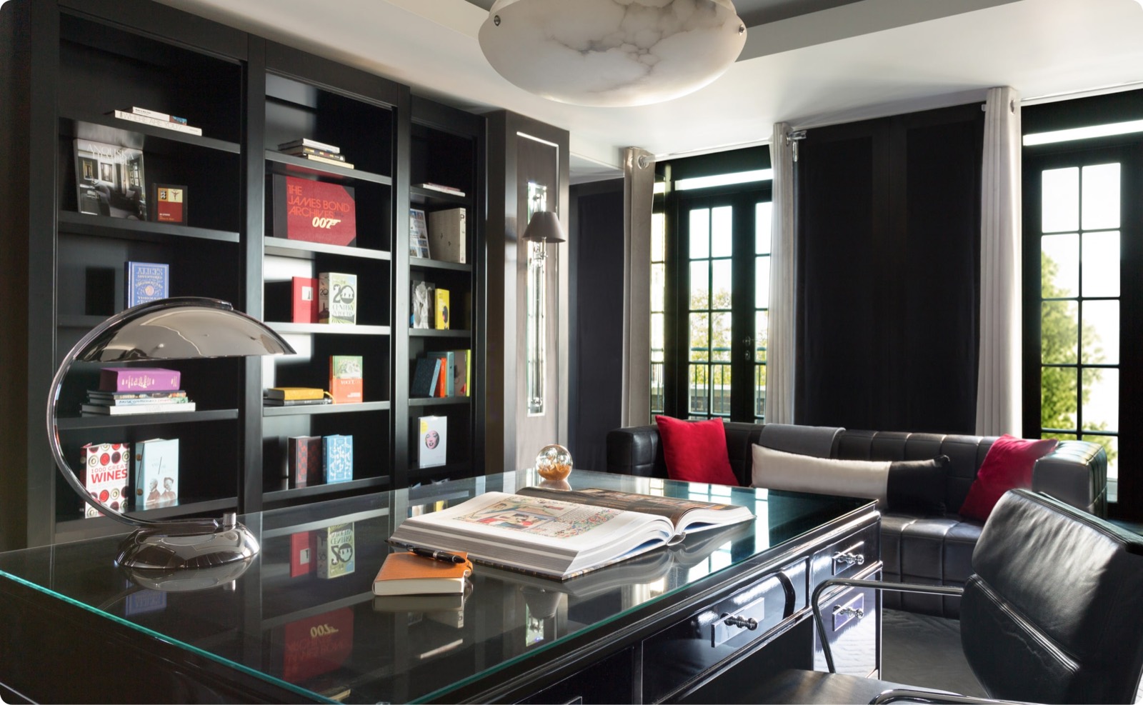 Study with glass desk and full bookshelves