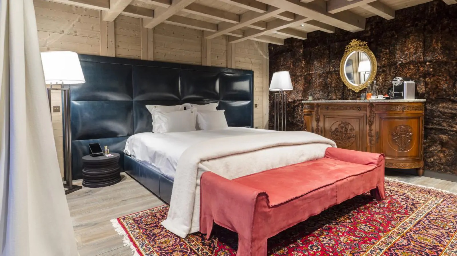 Bedroom with deep blue leather headboard