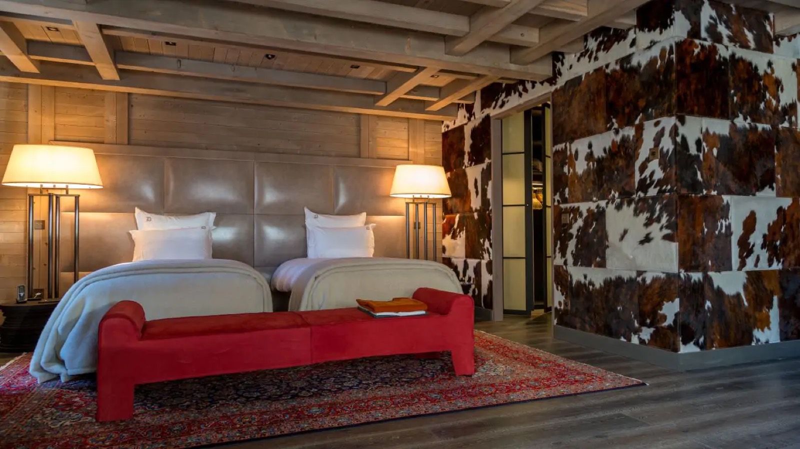 Twin bedroom with cowhide-panelled wall